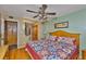 Bedroom features a ceiling fan, wood floors, and closet access at 5820 N Church Ave # 147, Tampa, FL 33614