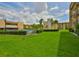 Exterior view of lush green lawn with the community pool in the background at 5820 N Church Ave # 147, Tampa, FL 33614