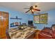 This dining room has a wood table, leather chairs, and a brown ceiling fan at 5820 N Church Ave # 147, Tampa, FL 33614