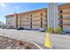Multi-story condo building with parking and a stone pillar at 5820 N Church Ave # 147, Tampa, FL 33614