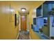 Hallway leading to kitchen with unique built-in shelving and wood closet at 5820 N Church Ave # 147, Tampa, FL 33614