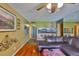 Living room open to kitchen with ceiling fan, tile flooring and a comfortable couch at 5820 N Church Ave # 147, Tampa, FL 33614