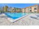 Resort-style pool with lounge chairs surrounded by lush landscaping at 5820 N Church Ave # 147, Tampa, FL 33614