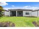 The home has a spacious backyard featuring a covered patio, perfect for outdoor living at 6072 Silver Grass Ct, Nokomis, FL 34275