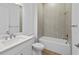 Bathroom boasts modern white vanity and a tiled shower and bath combo at 6072 Silver Grass Ct, Nokomis, FL 34275