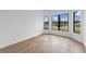 Bedroom with wood-look flooring and bright black framed windows, creating a modern look at 6072 Silver Grass Ct, Nokomis, FL 34275