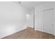 Bedroom with wood-look flooring and a closet with sliding doors at 6072 Silver Grass Ct, Nokomis, FL 34275
