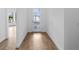 Bright entryway features a glass front door and wood-look tile flooring at 6072 Silver Grass Ct, Nokomis, FL 34275
