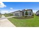 Well-maintained home showcasing a lush green lawn, paver driveway, and pristine exterior at 6072 Silver Grass Ct, Nokomis, FL 34275