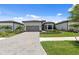 Charming home with a well-kept lawn, brick driveway, and inviting curb appeal at 6072 Silver Grass Ct, Nokomis, FL 34275