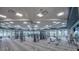 Modern gym is equipped with a variety of weight machines and fitness equipment with an airy, open design at 6072 Silver Grass Ct, Nokomis, FL 34275