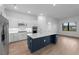 Open kitchen featuring a large island, stainless steel appliances, and plenty of natural light at 6072 Silver Grass Ct, Nokomis, FL 34275