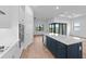 Stylish kitchen with a large island, stainless steel appliances, and views to the backyard at 6072 Silver Grass Ct, Nokomis, FL 34275