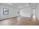 Bright, open living room with modern recessed lighting, light walls, and wood-style tile flooring at 6072 Silver Grass Ct, Nokomis, FL 34275