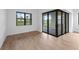 Bright living area with tile flooring, white walls, and sliding glass doors leading to an outdoor patio at 6072 Silver Grass Ct, Nokomis, FL 34275
