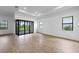 Spacious living room features modern lighting, tile flooring, and sliding glass doors to the outdoor living space at 6072 Silver Grass Ct, Nokomis, FL 34275