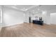 Open-concept living space showcasing a modern kitchen with stainless steel appliances and a kitchen island at 6072 Silver Grass Ct, Nokomis, FL 34275