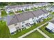 A beautiful aerial view of newly constructed townhomes with fenced yards and lush landscaping at 6235 Bucket Ct, Gibsonton, FL 33534