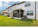 View of townhomes with a screened in porch in the backyard and AC unit at 6235 Bucket Ct, Gibsonton, FL 33534