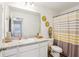 Clean bathroom with a vanity and a shower with a stylish patterned curtain at 6235 Bucket Ct, Gibsonton, FL 33534