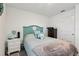 Comfortable bedroom with a teal seashell headboard, offering a relaxing, beachy vibe at 6235 Bucket Ct, Gibsonton, FL 33534