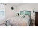 Serene bedroom featuring a decorative teal headboard with seashell accents and calming decor at 6235 Bucket Ct, Gibsonton, FL 33534