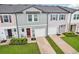 Exterior shot of townhome featuring gray paint, dark shutters, 2 car garage, and well-maintained landscaping at 6235 Bucket Ct, Gibsonton, FL 33534