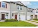 Attractive townhome exterior with a cozy porch, garage, and vibrant green lawn at 6235 Bucket Ct, Gibsonton, FL 33534