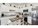Bright kitchen features stainless steel appliances, granite countertops, ample white cabinets, and center island at 6235 Bucket Ct, Gibsonton, FL 33534