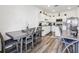 Eat-in kitchen with stainless steel appliances, granite counters, and modern wooden table at 6235 Bucket Ct, Gibsonton, FL 33534