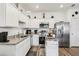 Modern kitchen with stainless steel appliances, granite countertops, and white cabinetry at 6235 Bucket Ct, Gibsonton, FL 33534