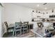 Eat-in kitchen with stainless steel appliances, granite counters, and modern wooden table at 6235 Bucket Ct, Gibsonton, FL 33534