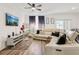 Bright living room with neutral walls, wood floors, ceiling fan, and stylish furnishings at 6235 Bucket Ct, Gibsonton, FL 33534