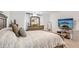 Main bedroom features soft carpet, gray curtains, queen-size bed and a TV mounted to the wall at 6235 Bucket Ct, Gibsonton, FL 33534