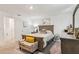 Main bedroom with a queen-size bed, dresser with mirror and a decorative bench with yellow throw pillow at 6235 Bucket Ct, Gibsonton, FL 33534