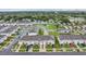 Aerial shot of a vibrant community featuring well-maintained townhomes, green spaces, and a tranquil pond at 6235 Bucket Ct, Gibsonton, FL 33534