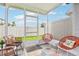 Enclosed patio featuring stylish outdoor seating and a peek at the green yard beyond at 6235 Bucket Ct, Gibsonton, FL 33534