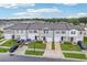 Aerial view showcasing the street of townhomes in a well-maintained community with lush green lawns at 6235 Bucket Ct, Gibsonton, FL 33534