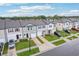Aerial view of townhomes on a street lined with manicured lawns and mature trees, showcasing the neighborhood at 6235 Bucket Ct, Gibsonton, FL 33534