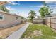 Private backyard featuring a well-maintained lawn, mature trees, and a walkway to a detached shed at 6944 80Th N Ave, Pinellas Park, FL 33781