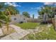 Well-maintained backyard with mature trees, a lush lawn, and a wood fence creating a private outdoor retreat at 6944 80Th N Ave, Pinellas Park, FL 33781