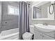 Modern bathroom featuring gray tile, a new vanity, and updated fixtures at 6944 80Th N Ave, Pinellas Park, FL 33781