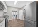 Bright kitchen featuring stainless steel appliances, white cabinetry, and wood floors at 6944 80Th N Ave, Pinellas Park, FL 33781