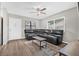 Comfortable living room with a ceiling fan, large sectional sofa, and natural light from the windows at 6944 80Th N Ave, Pinellas Park, FL 33781