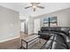 Comfortable living room with a ceiling fan, large sectional sofa, and natural light from the windows at 6944 80Th N Ave, Pinellas Park, FL 33781