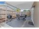 Covered patio with grill, outdoor dining set, and privacy fence creating a cozy entertainment space at 6944 80Th N Ave, Pinellas Park, FL 33781