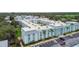 Aerial view of the property showing ample parking, green spaces and mature landscaping at 701 Poinsettia Rd # 322, Belleair, FL 33756