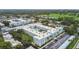 Aerial view of the complex featuring a pool and lots of green trees and golf course at 701 Poinsettia Rd # 322, Belleair, FL 33756