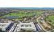 Aerial view showcases the condo community's proximity to golf course and nearby waterfront at 701 Poinsettia Rd # 322, Belleair, FL 33756