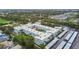 Aerial view of the complex featuring a pool and lots of green trees at 701 Poinsettia Rd # 322, Belleair, FL 33756